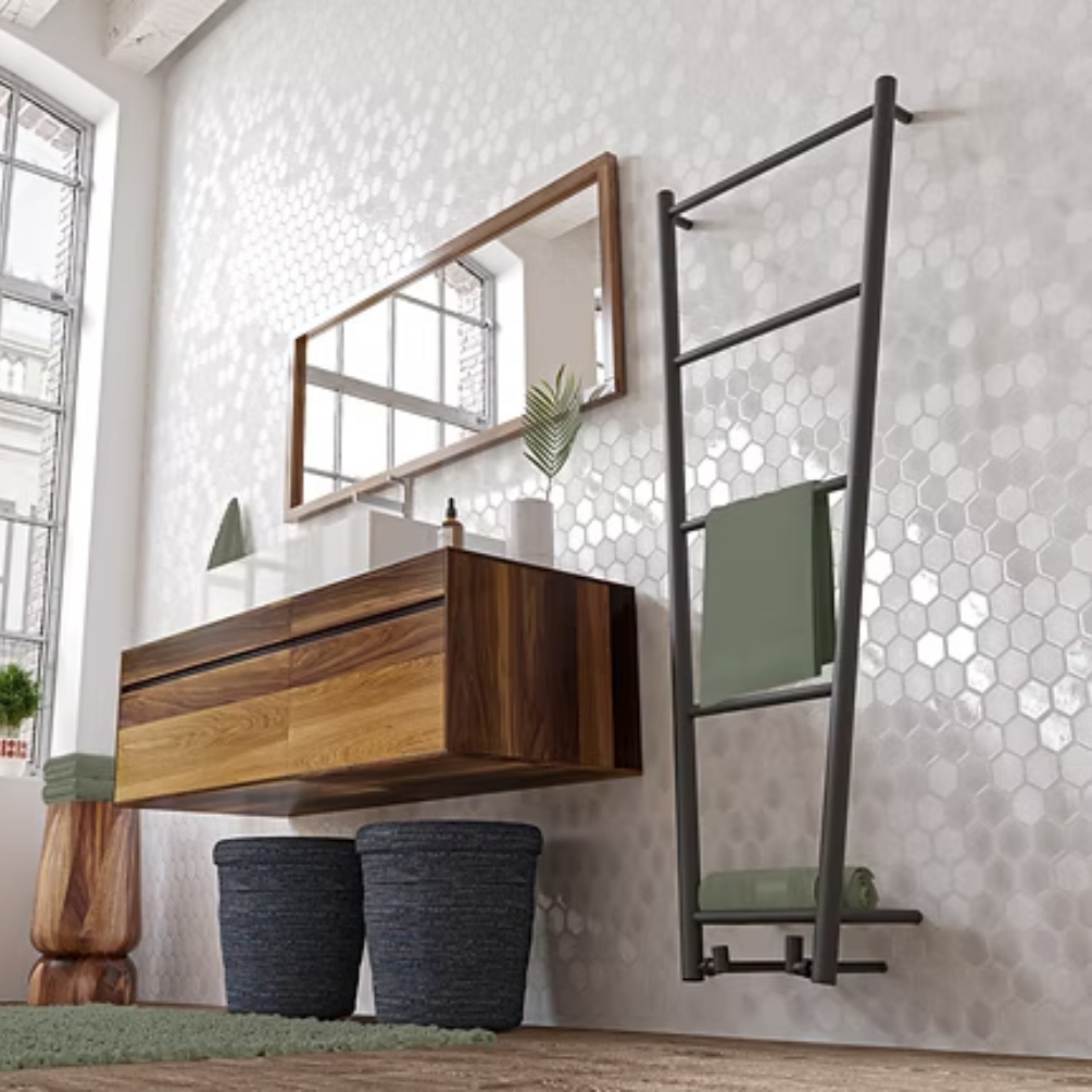 Lifestyle image of the Radox Flyn 1650mm x 650mm Black Pearl Heated Towel Radiator mounted on a bathroom wall next to a wall-mounted vanity unit